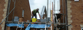 A builder working on a roof